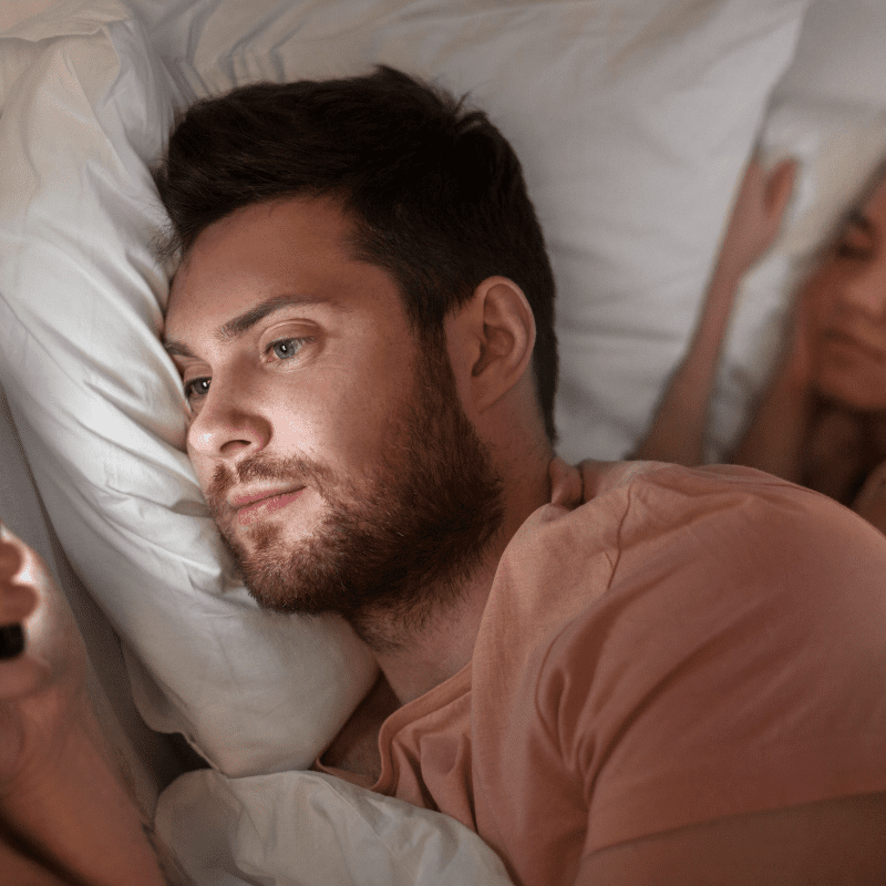 Talking on the phone to someone else: cheating while wife is in bed